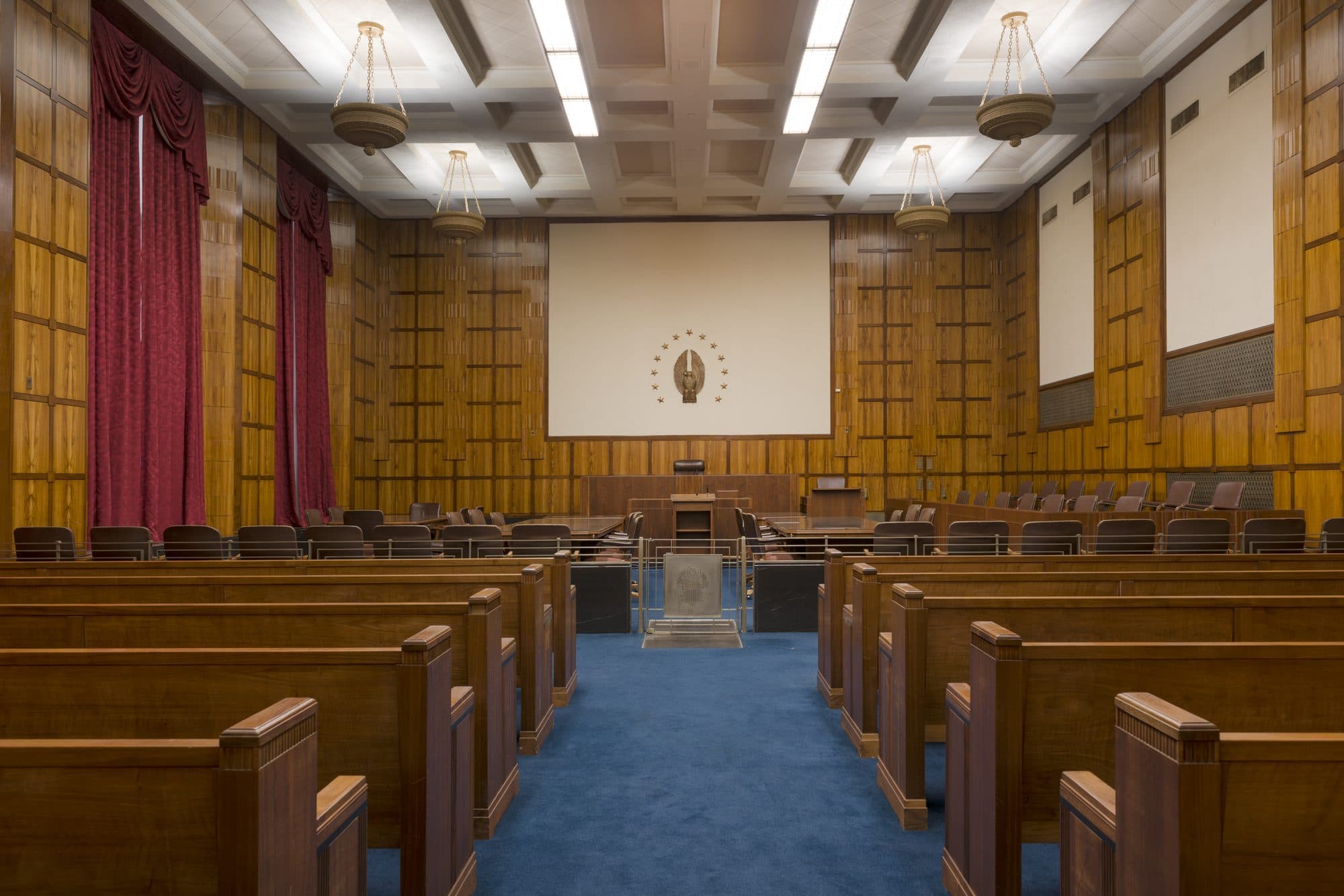 An empty wood-paneled federal courtroom in the U.S. Court House in Austin, Texas.