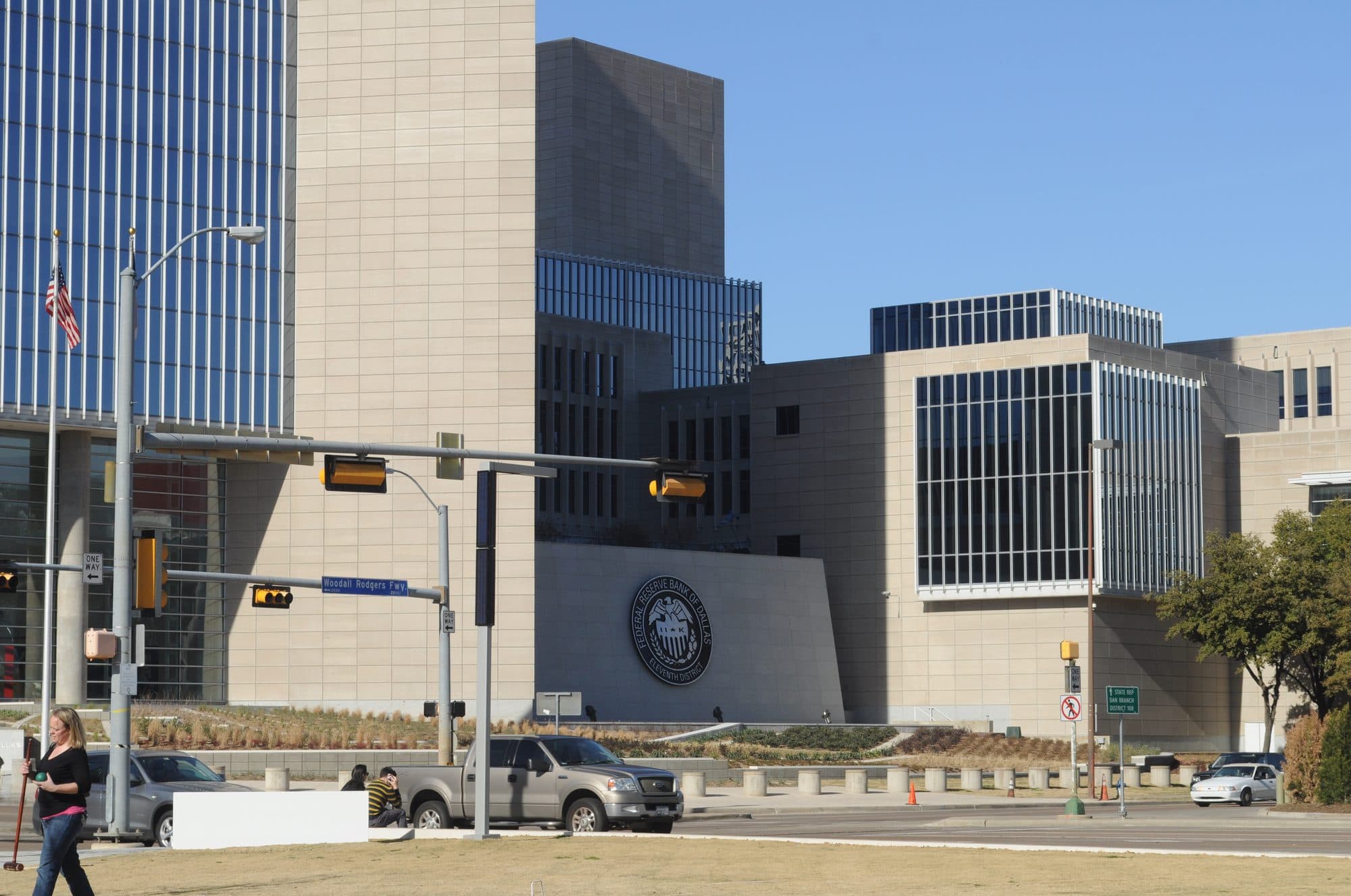 The Federal Reserve Bank of Dallas building on a sunny day, seen from a downtown intersection.